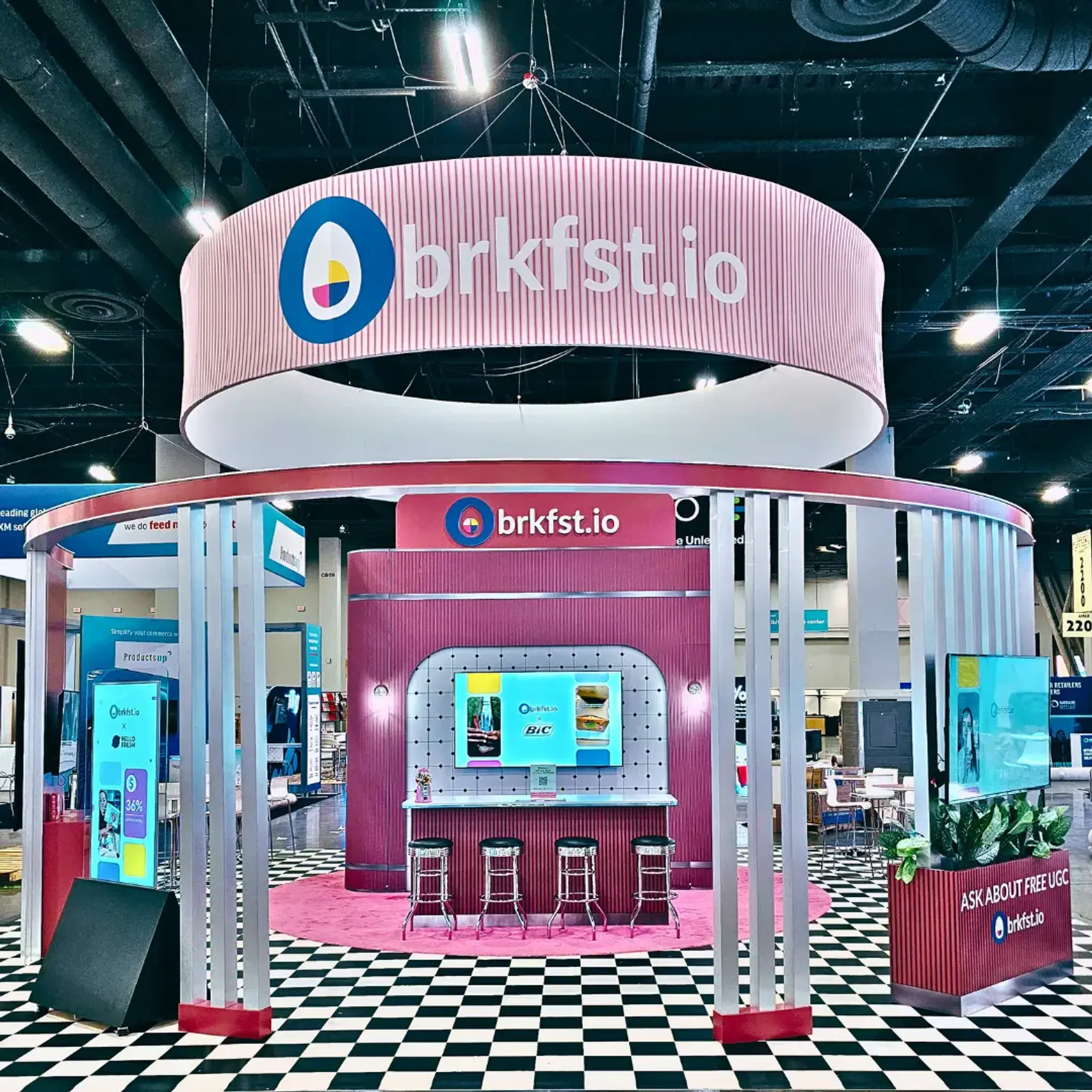 20x20 Island booth design by Highway 85 Creative